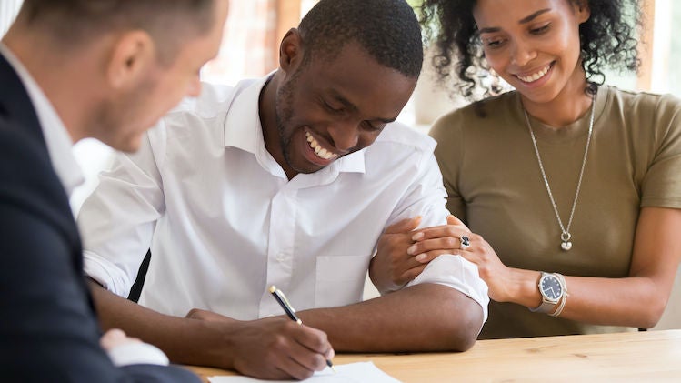 Image of couple signing contract