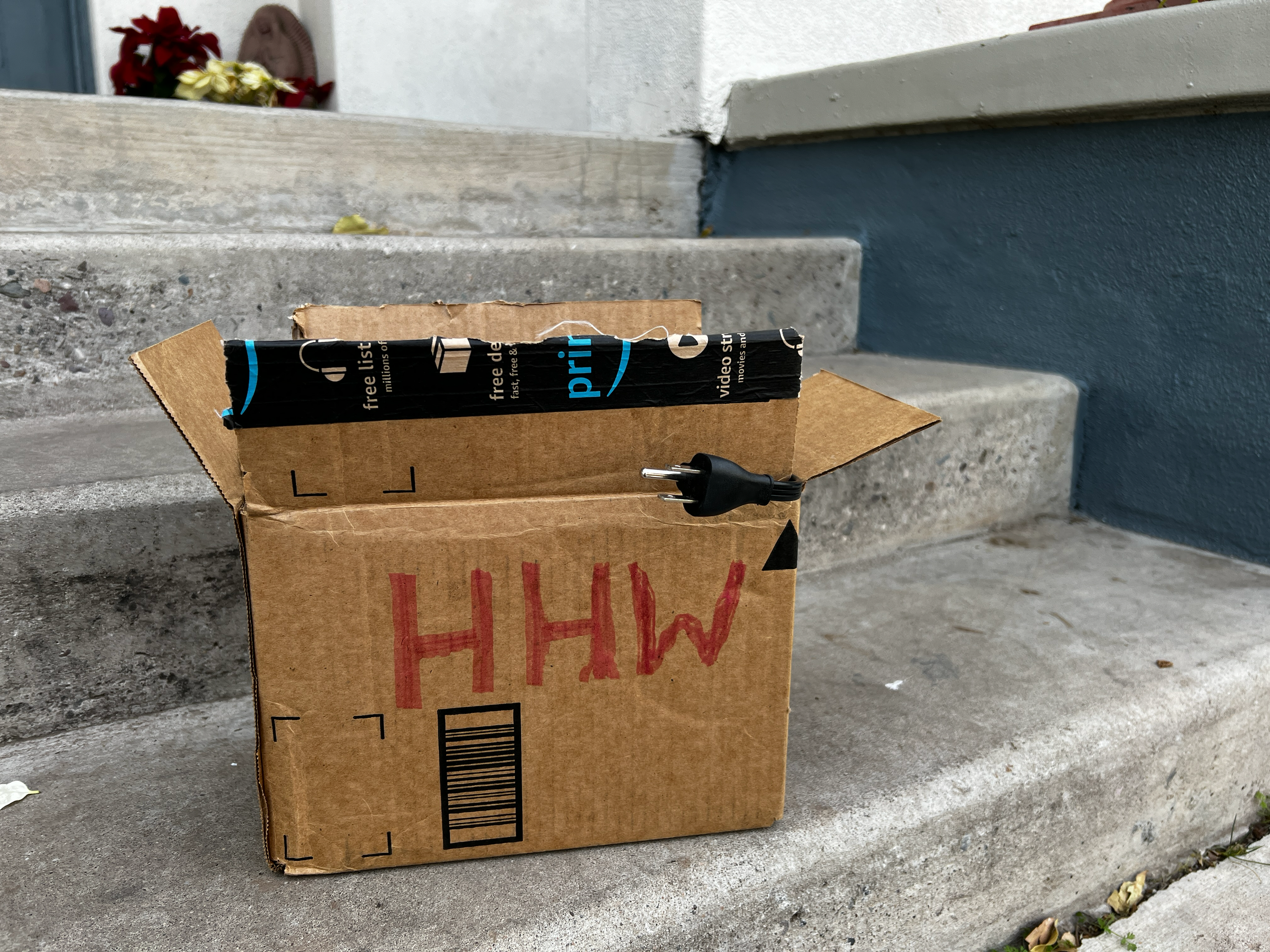 A person loads boxes of household hazardous waste into a truck.
